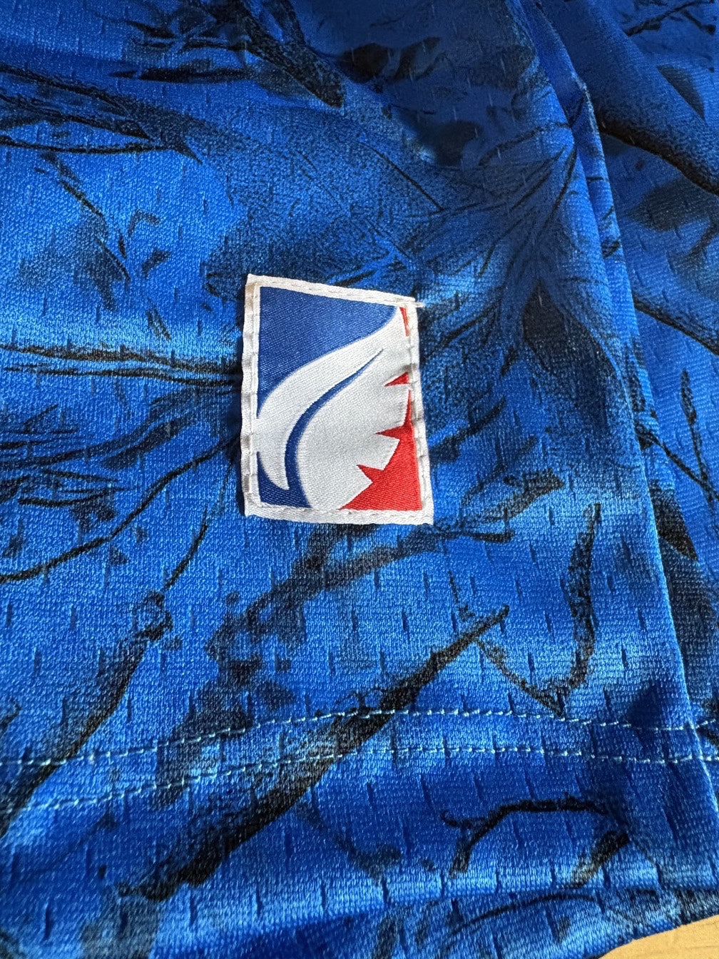 Leaf performance mesh shorts in electric blue with dark hunting camo print and a branded logo patch detail