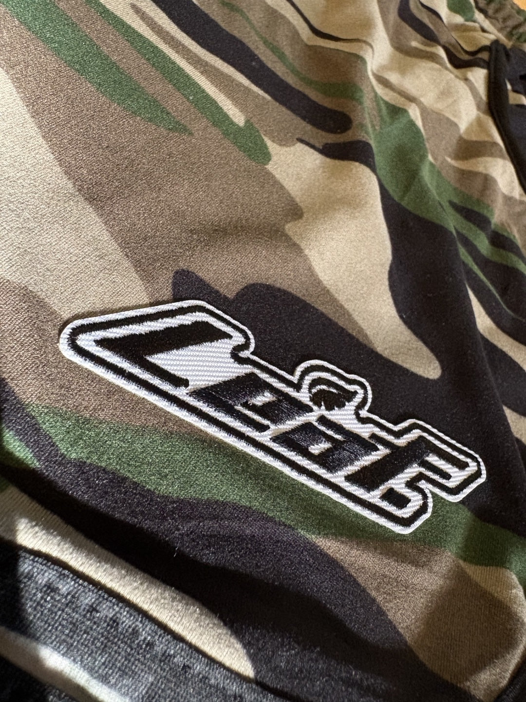 Leaf athletic performance training shorts in earthy camo print with embroidered brand logo and black trim detail