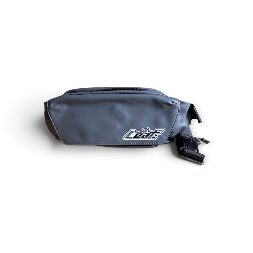 Leaf matte black water-resistant waist pack with an embroidered brand patch and adjustable nylon strap.